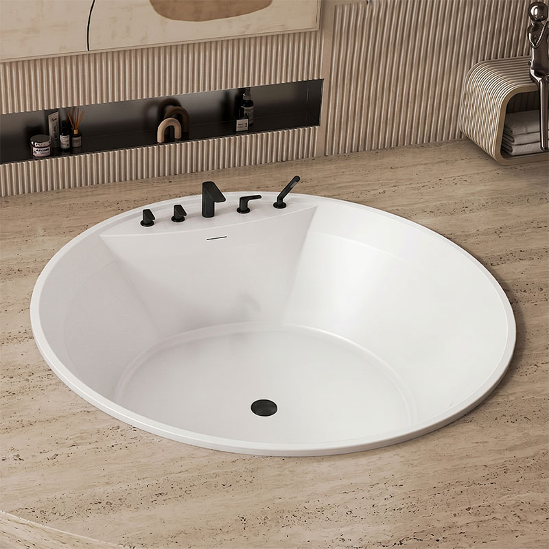 White circular bathtub with black faucet and controls in a modern bathroom beige stone floor and textured wall panels behind a recessed shelf